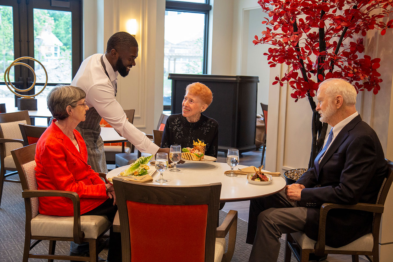 waiter serving people at table