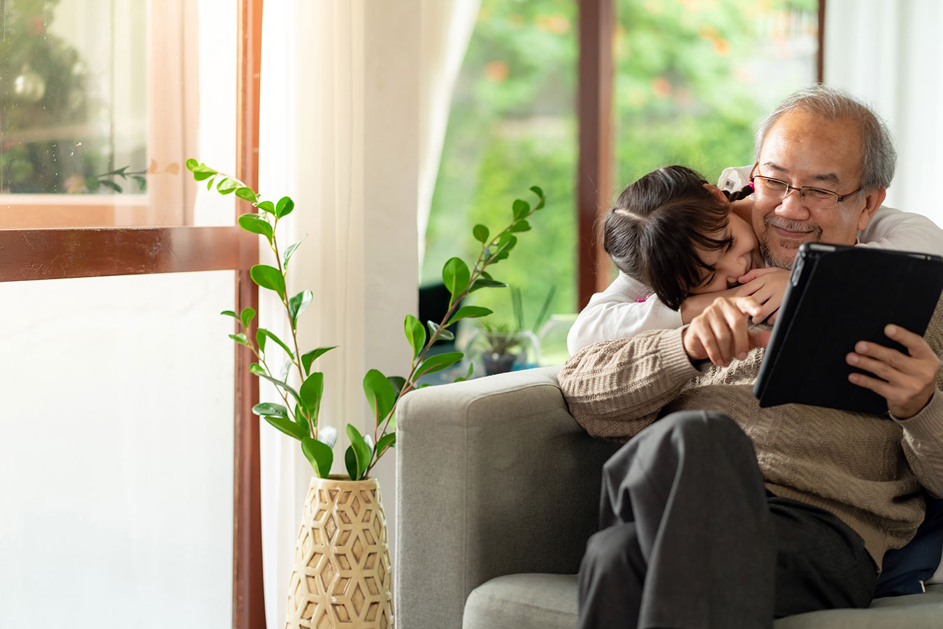 grandfather reading to granddaughter