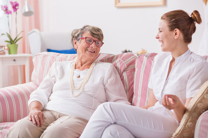 woman laughing with caregiver