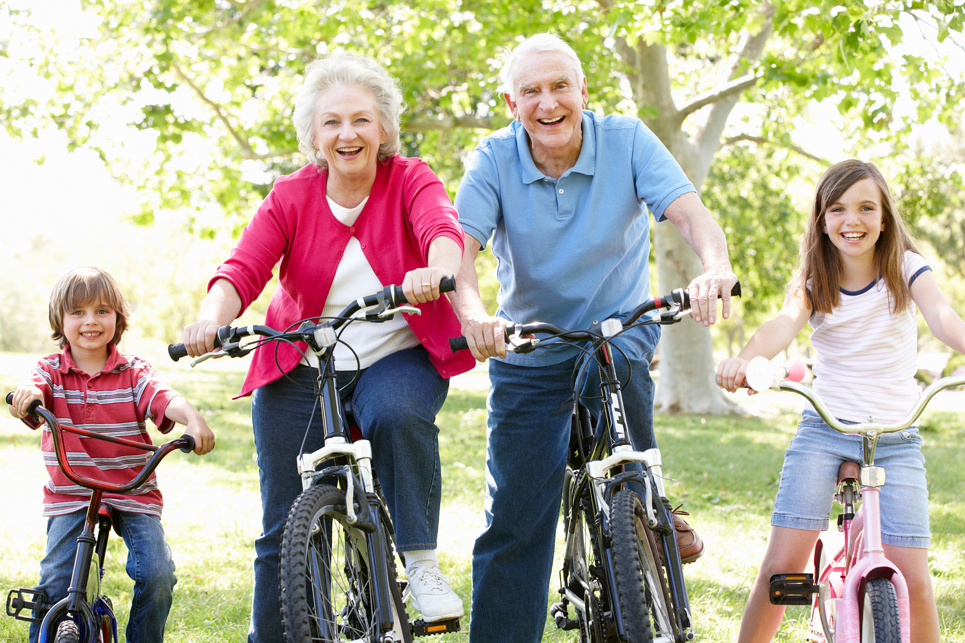 Senior adults bike riding with grandkids.