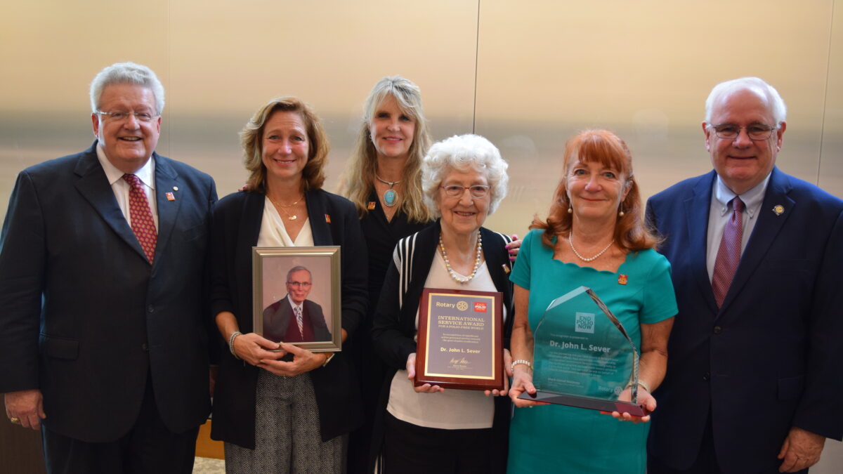 Dr. Sever's family with his awards and recognitions.