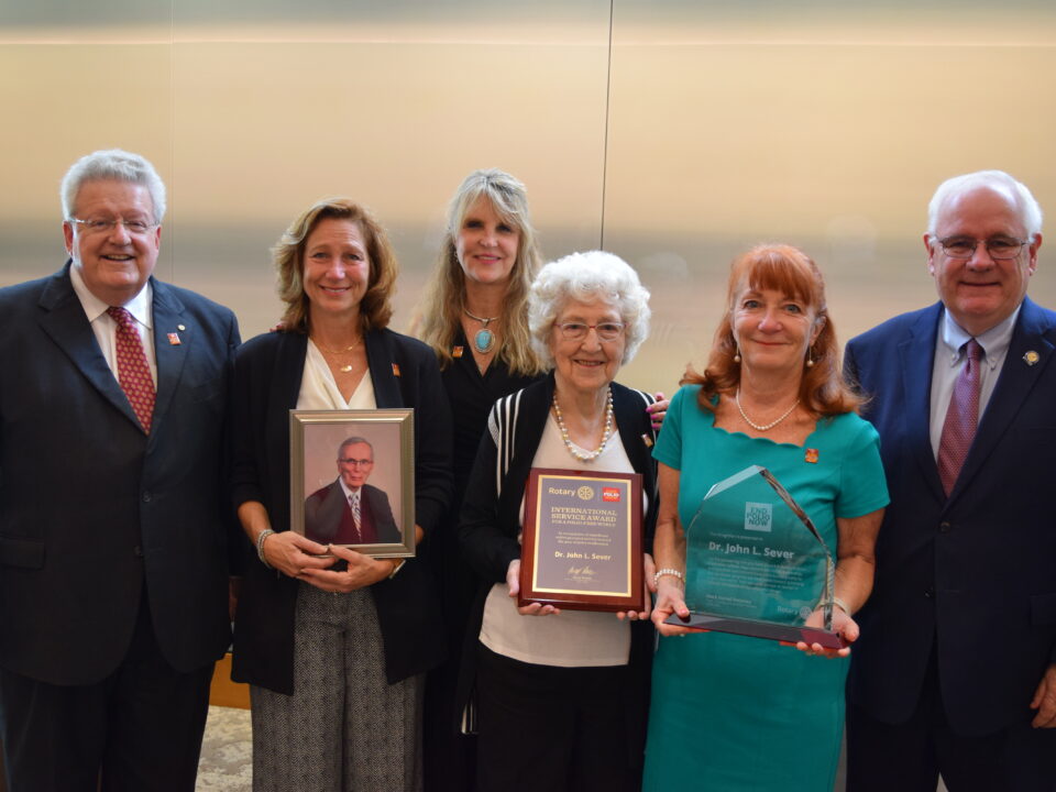 Dr. Sever's family with his awards and recognitions.