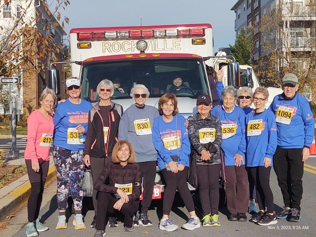 Group of IKF runners posed in front of a Rockville Ambulance at the 5K