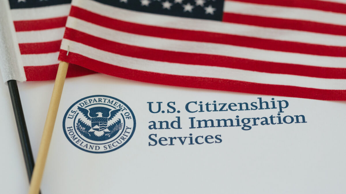 U.S. flag and citizenship and immigration paperwork