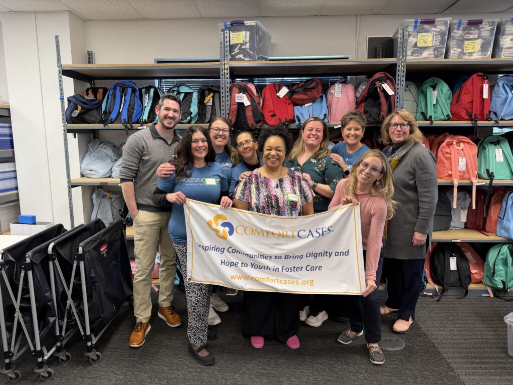 Ingleside team holding comfort cases banner 